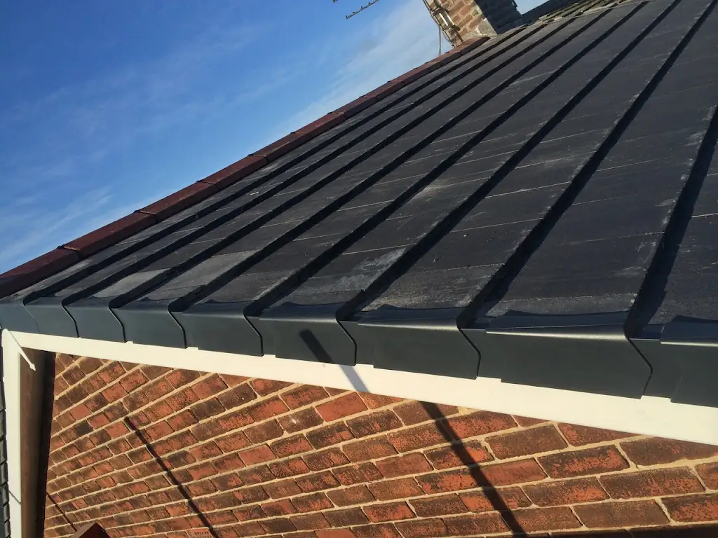 New slate-style roof tiles with dry verge finishing